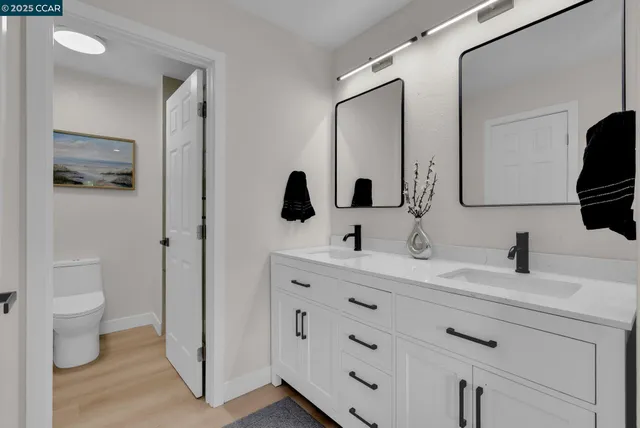 a bathroom with a double vanity sink and mirror