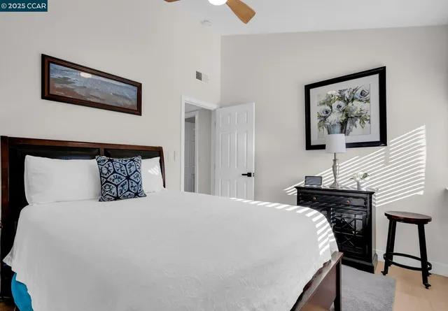 a bedroom with a bed and a desk