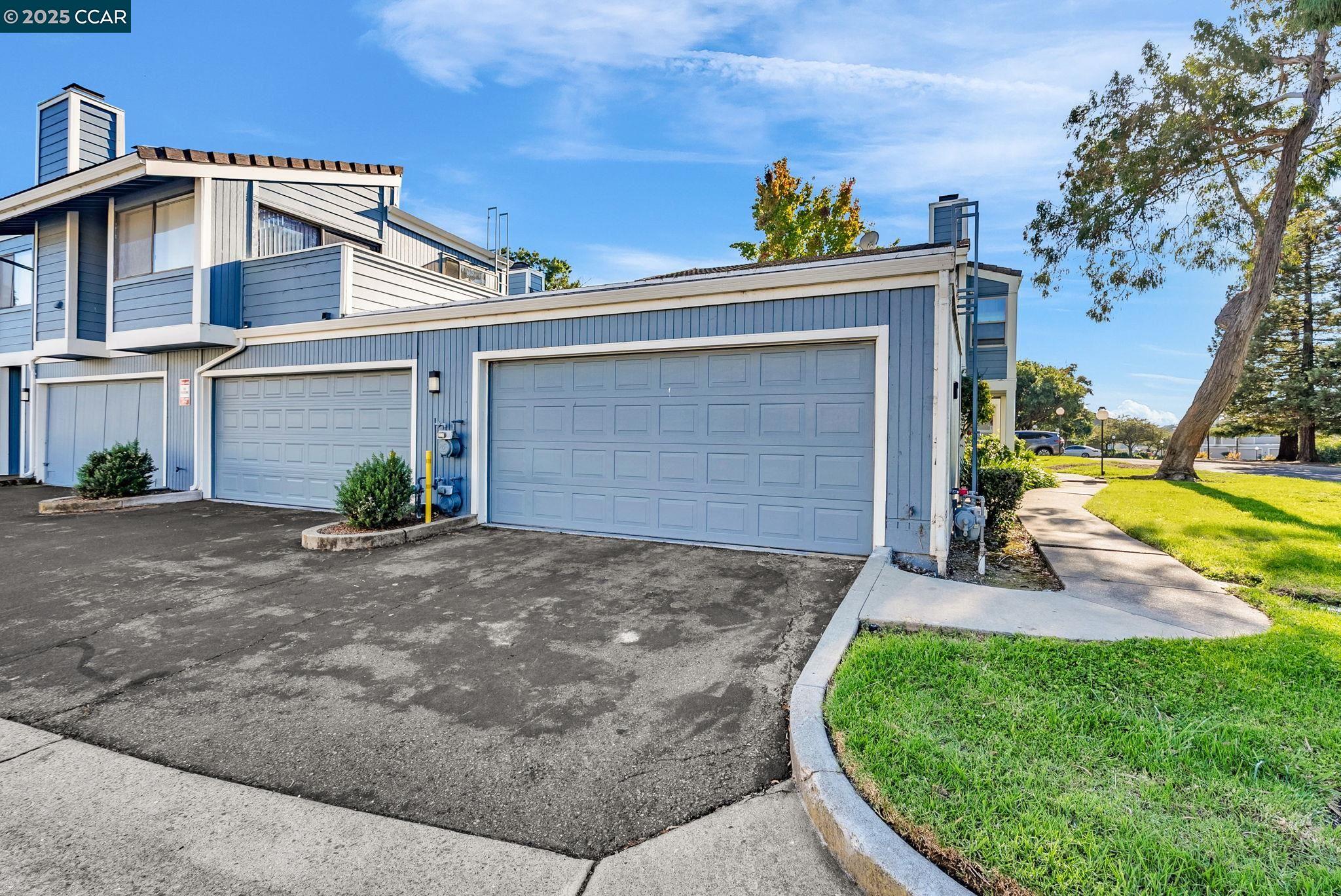 406 Olympus, Unit 5 Hercules, CA 94547 - Photo 38 of 49 a view of a house with a yard potted plants and a large tree