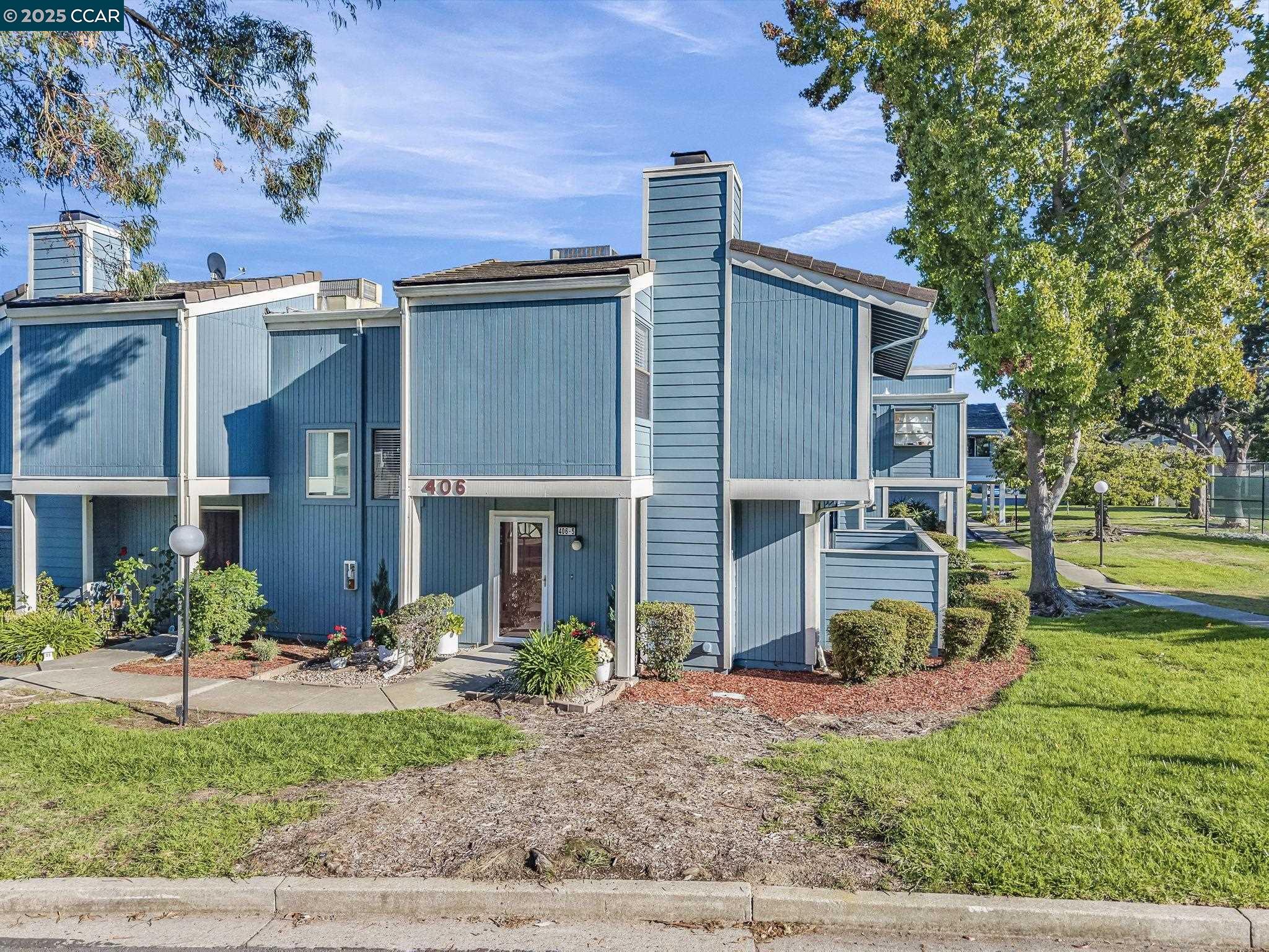 406 Olympus, Unit 5 Hercules, CA 94547 - Photo 39 of 49 a view of a house with a yard and plants