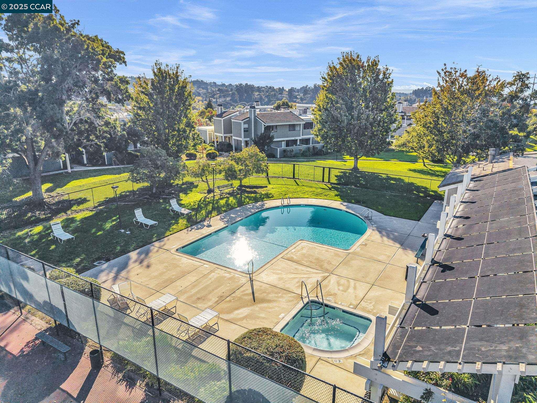 406 Olympus, Unit 5 Hercules, CA 94547 - Photo 42 of 49 a view of a swimming pool with a lounge chairs