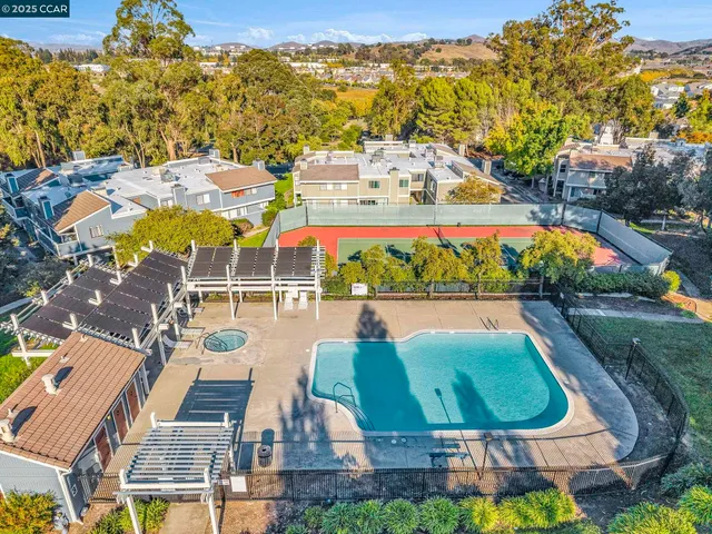 an aerial view of residential houses with outdoor space and swimming pool