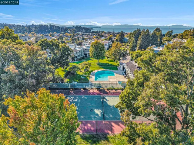 an aerial view of a houses with a swimming pool