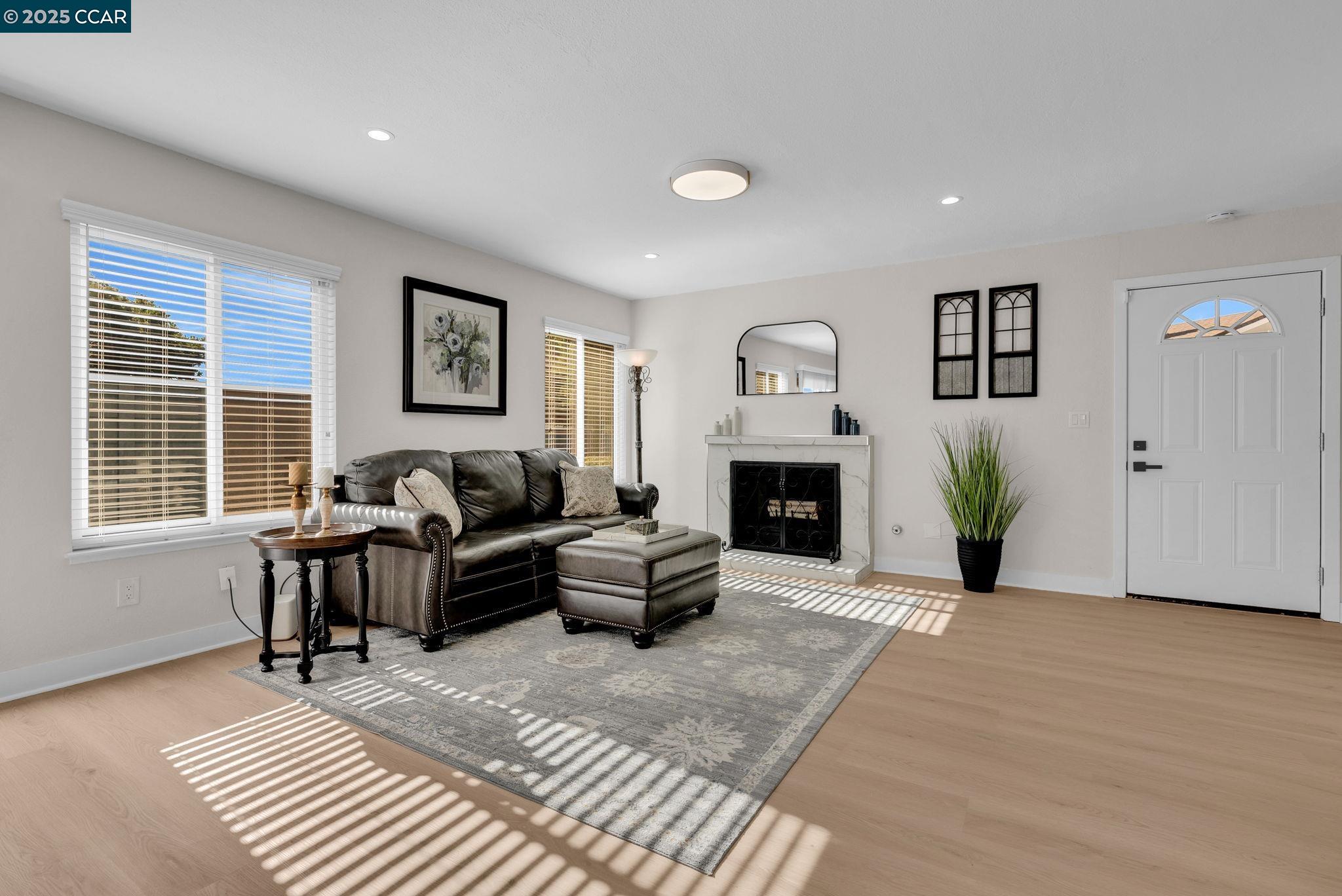 406 Olympus, Unit 5 Hercules, CA 94547 - Photo 5 of 49 a living room with furniture and a fireplace