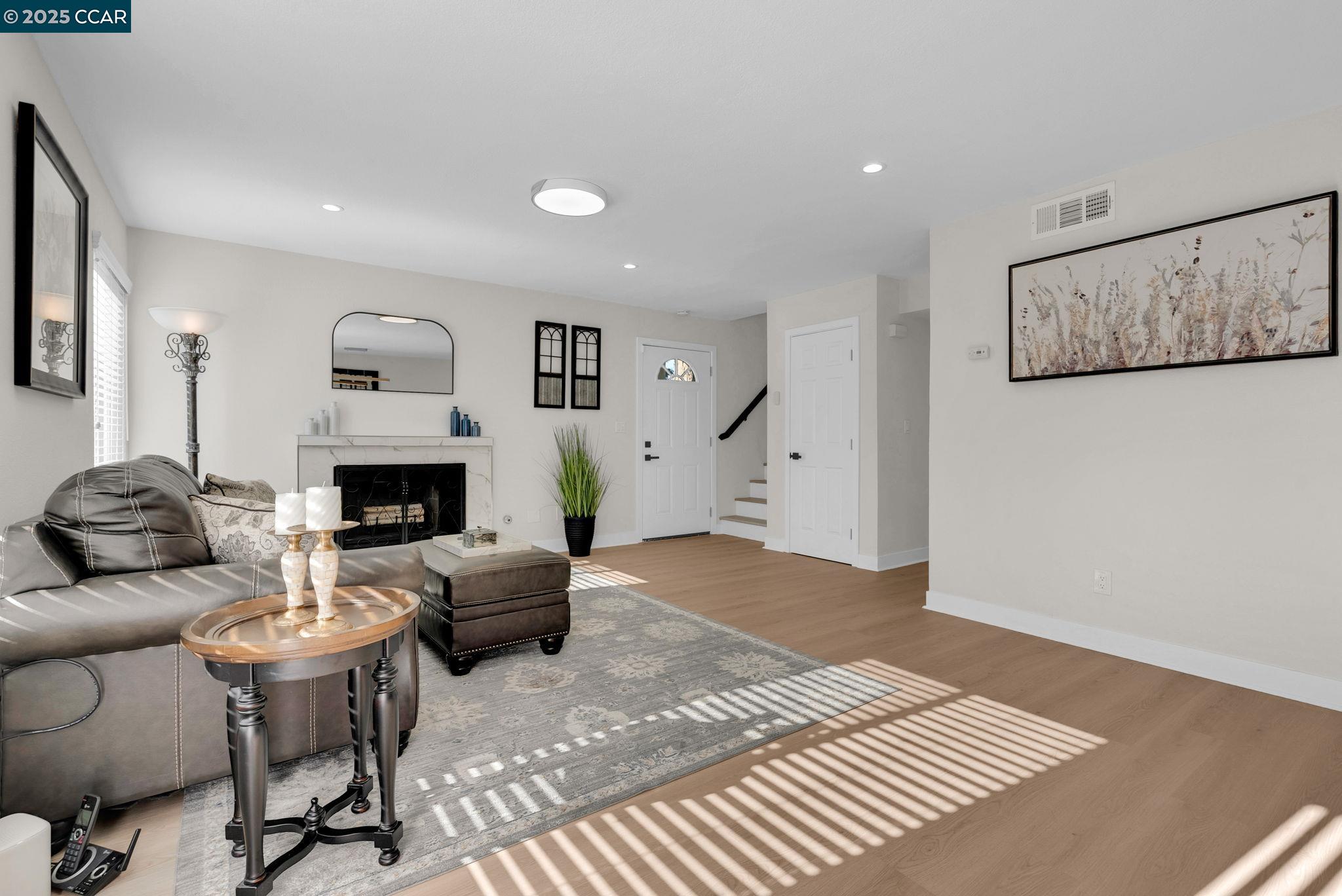 406 Olympus, Unit 5 Hercules, CA 94547 - Photo 6 of 49 a living room with furniture and a fireplace