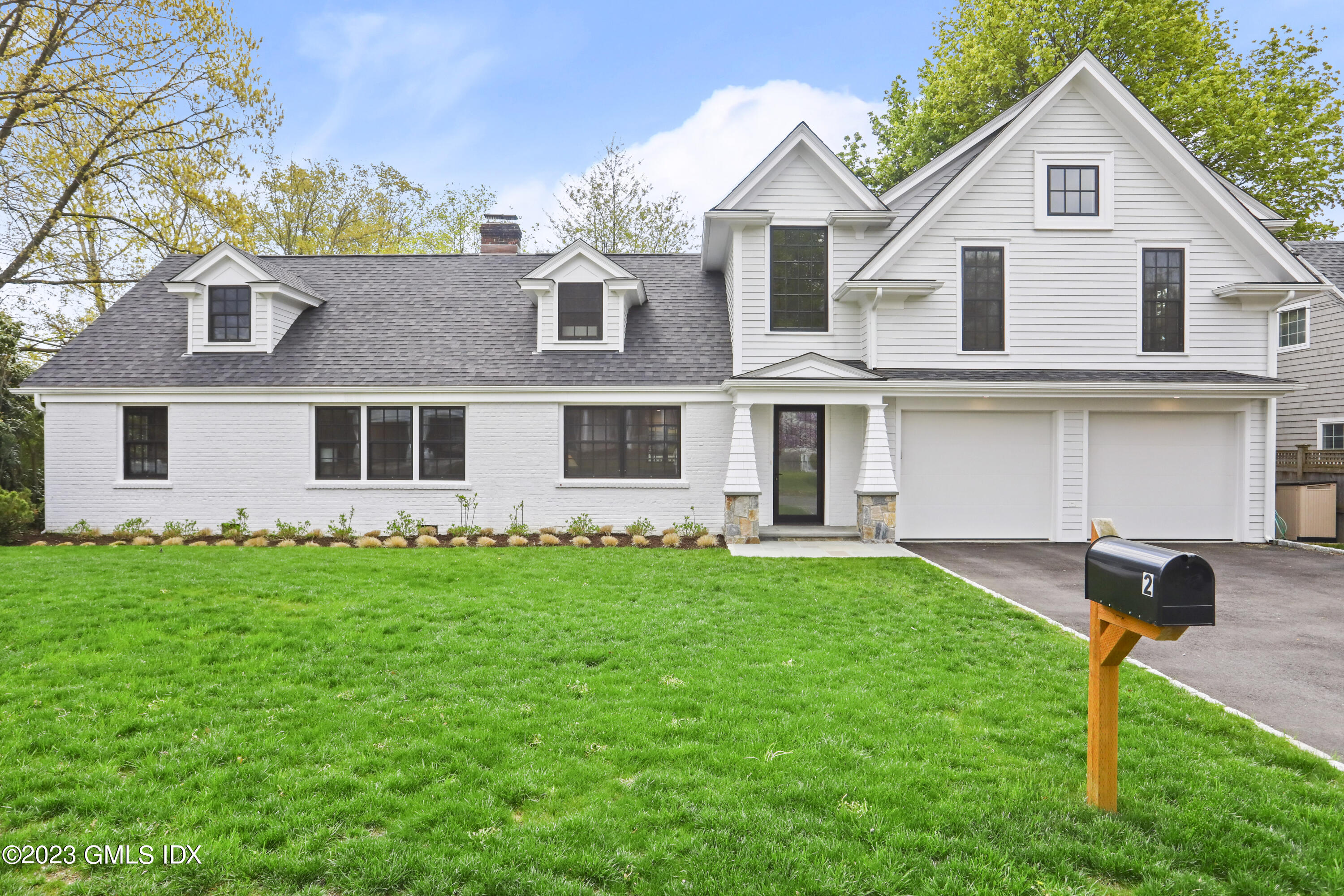 2 Northridge Road Old Greenwich, CT 06870 - Photo 2 of 43 a view of a yard in front of a house with large windows