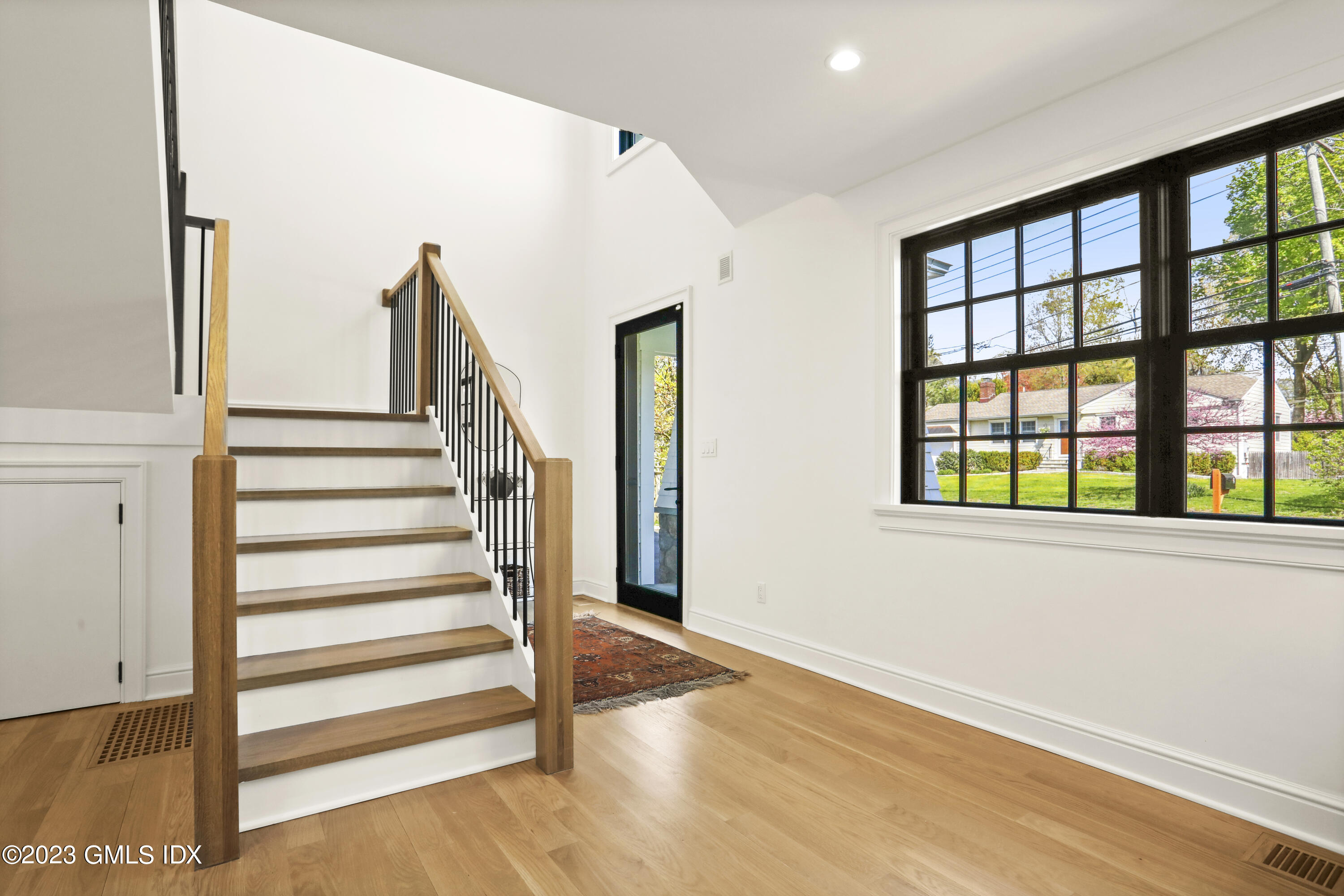 2 Northridge Road Old Greenwich, CT 06870 - Photo 3 of 43 a view of a livingroom with wooden floor and white walls