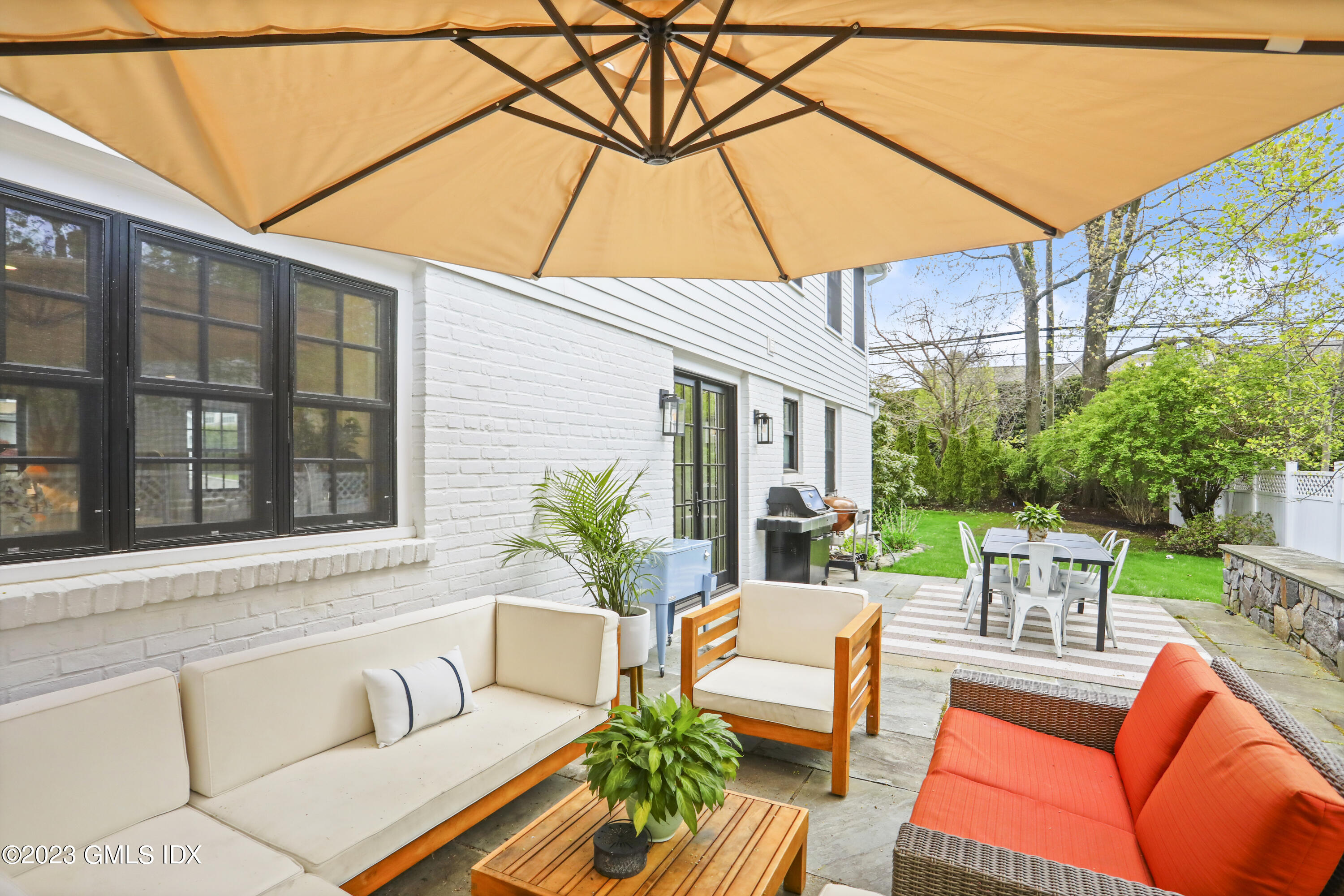 2 Northridge Road Old Greenwich, CT 06870 - Photo 33 of 43 a view of a patio with couches and a table and chairs