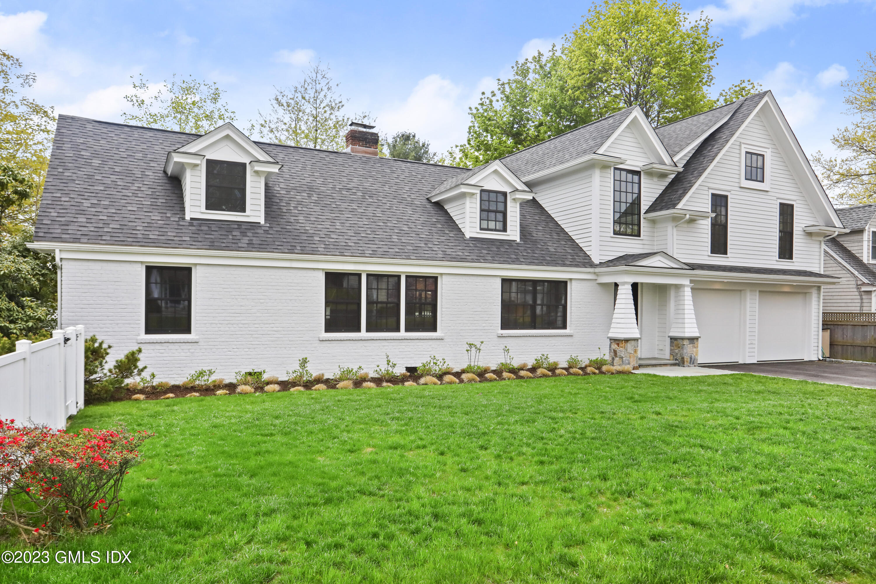 2 Northridge Road Old Greenwich, CT 06870 - Photo 43 of 43 a front view of a house with a garden