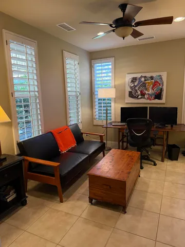 a living room with furniture a air conditioner vent and a window