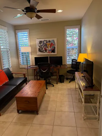 a living room with furniture a window and a flat screen tv
