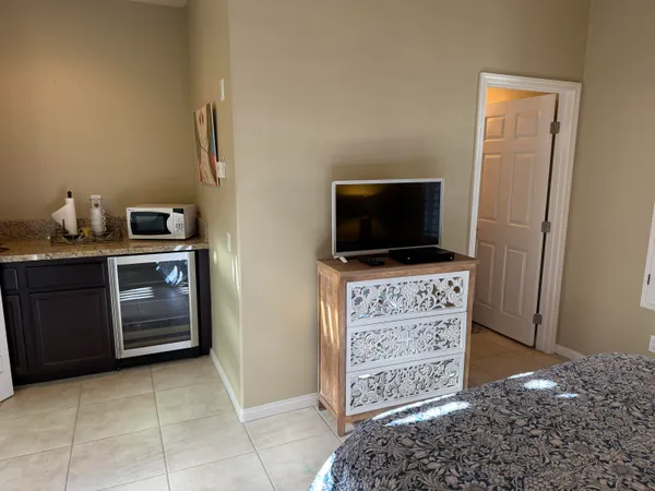 a view of kitchen with cabinets and flat screen tv