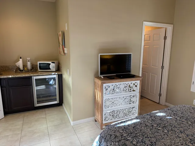 a view of kitchen with cabinets and flat screen tv