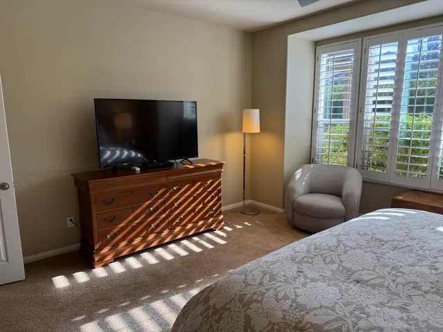 a bedroom with furniture and flat screen tv