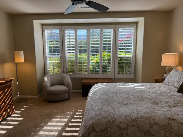 a bedroom with furniture and a large window