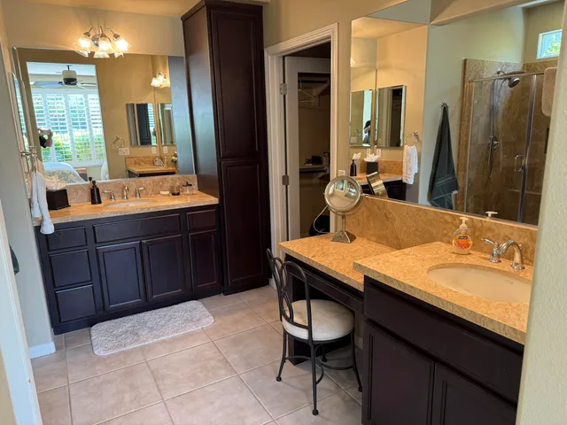 a bathroom with a granite countertop sink a mirror and a bathtub
