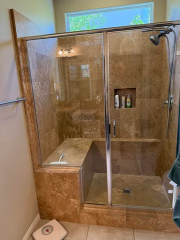 a bathroom with a shower and toilet