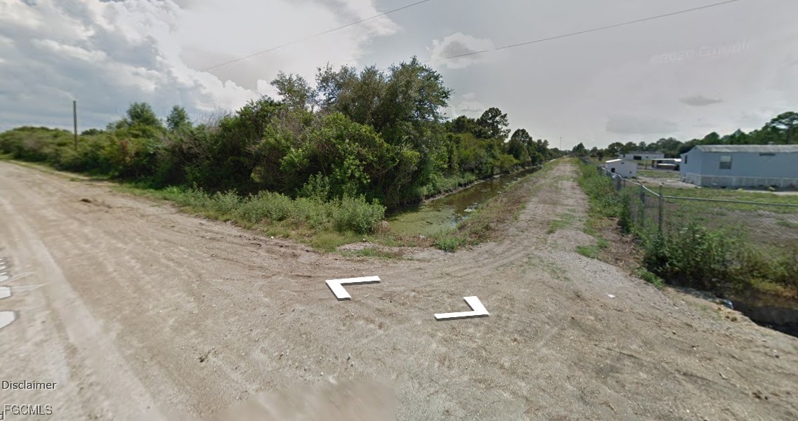 210 South Datil Street Clewiston, FL 33440 - Photo 3 of 4 a view of a dry yard with wooden fence