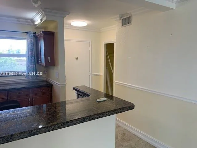 a view of a hallway with a sink and wooden floor
