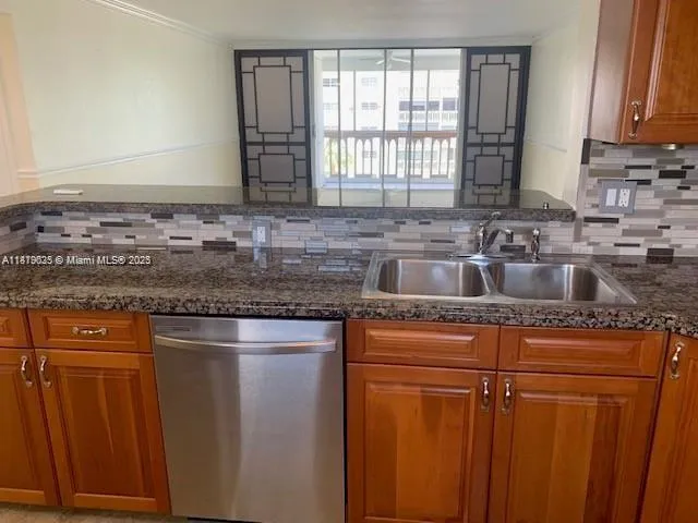 a kitchen with granite countertop cabinets sink and window