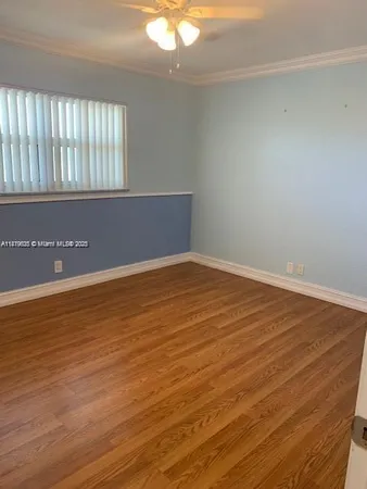 an empty room with wooden floor