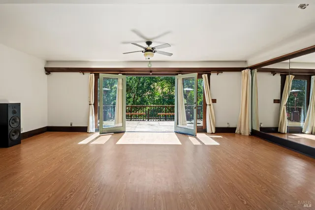 a view of balcony with wooden floor and barbeque oven