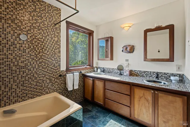 a view of a balcony with wooden floor and iron fence