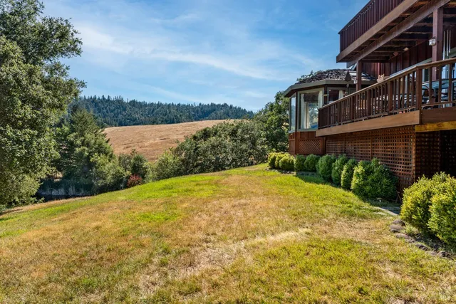a view of a outdoor sitting area with chairs and umbrellas