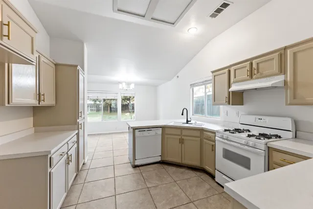 a kitchen with a sink stove and cabinets
