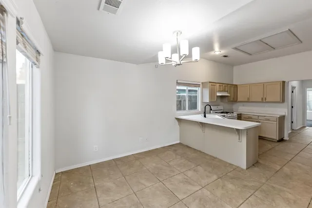 a kitchen with a sink cabinets and window