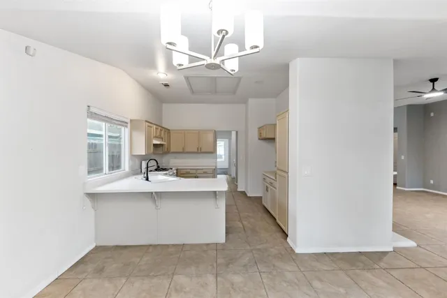 a kitchen with kitchen island a sink a stove and refrigerator