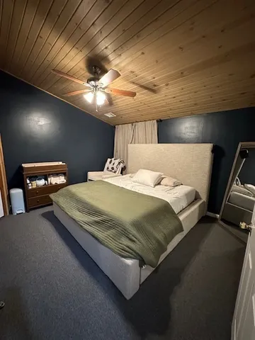 a bedroom with a bed and a tv
