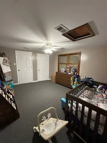 a bedroom with furniture and a window