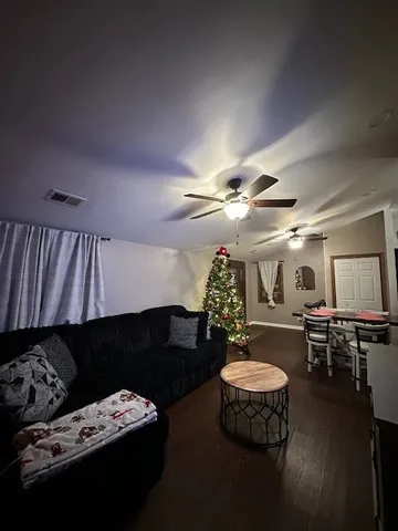 a living room with furniture and a chandelier