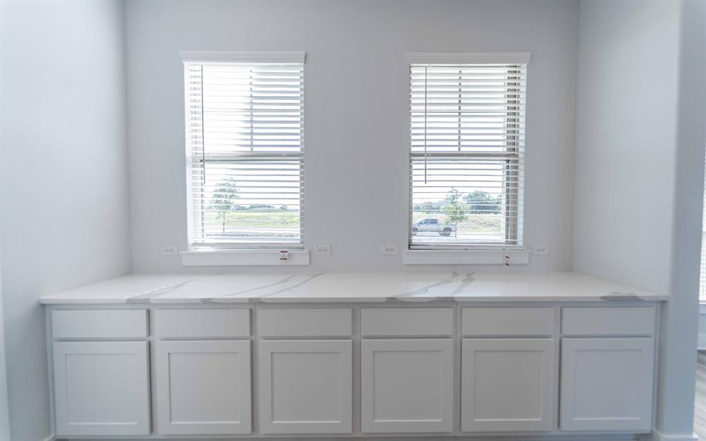 2012 Casting Ridge Mesquite, TX 75181 - Photo 12 of 28 a kitchen with white cabinets and a window