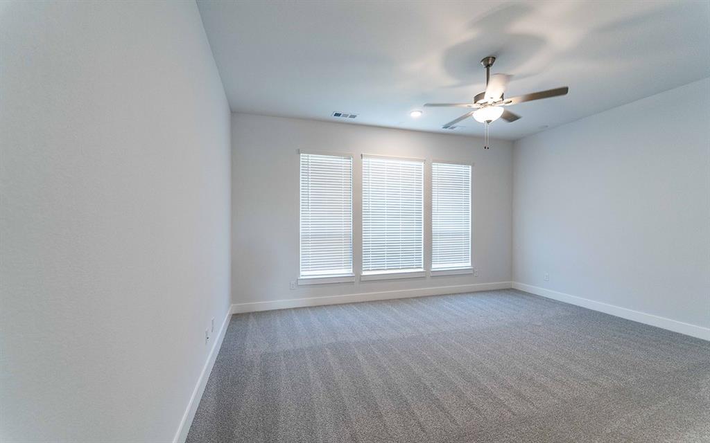 2012 Casting Ridge Mesquite, TX 75181 - Photo 15 of 28 an empty room with wooden floor fan and windows