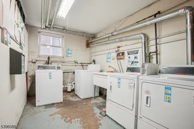 a utility room with cabinets washer and dryer