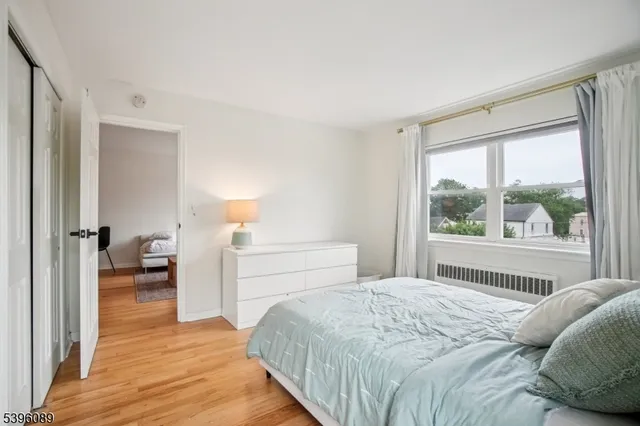 a bedroom with a bed and a large window