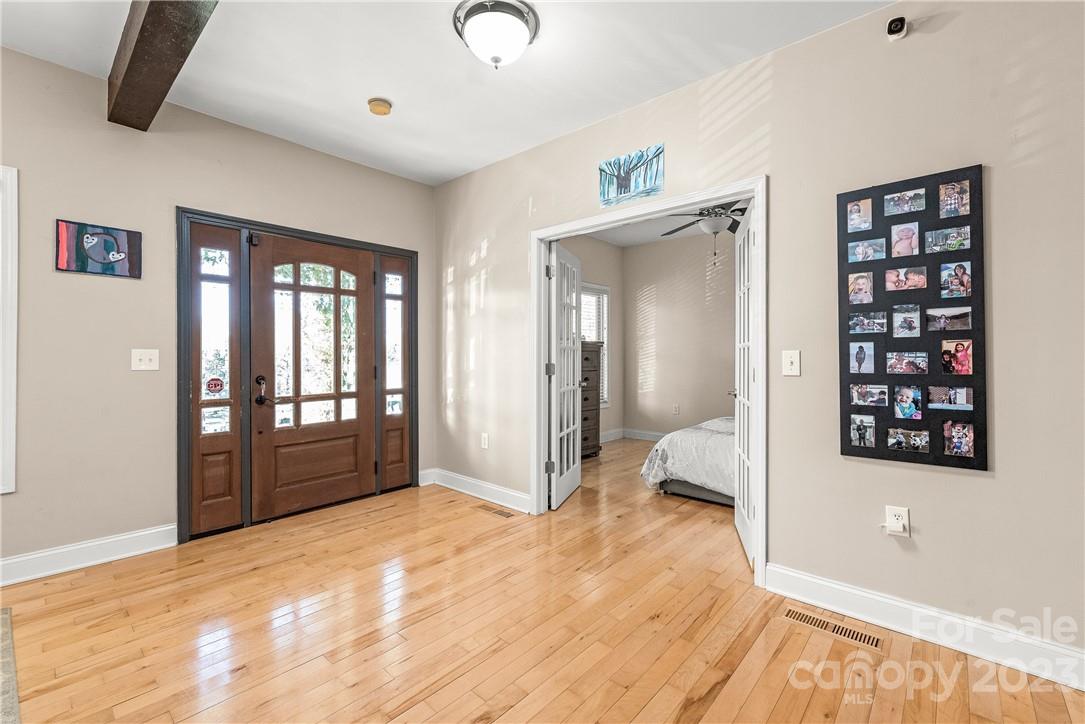 13801 East Rocky River Road Davidson, NC 28036 - Photo 11 of 42 a view of an empty room with wooden floor and a window