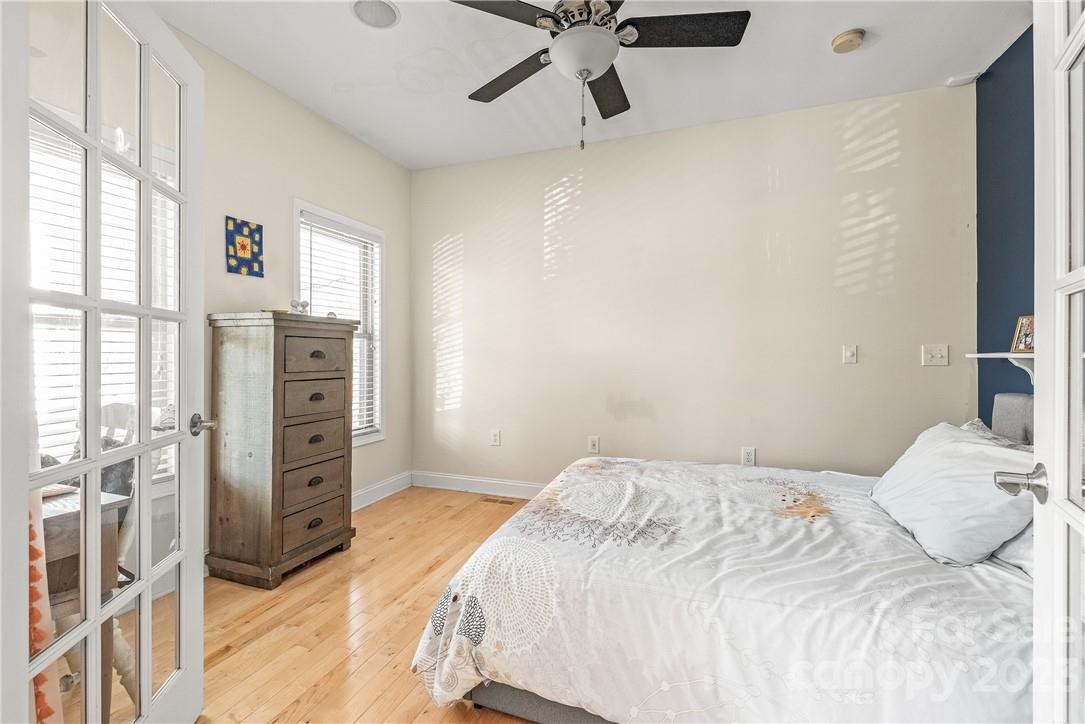 13801 East Rocky River Road Davidson, NC 28036 - Photo 14 of 42 a bedroom with a bed dresser and a window