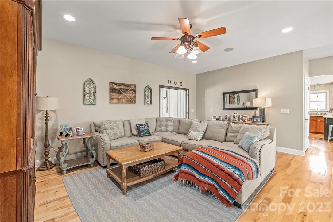 13801 East Rocky River Road Davidson, NC 28036 - Photo 16 of 42 a living room with furniture and a chandelier