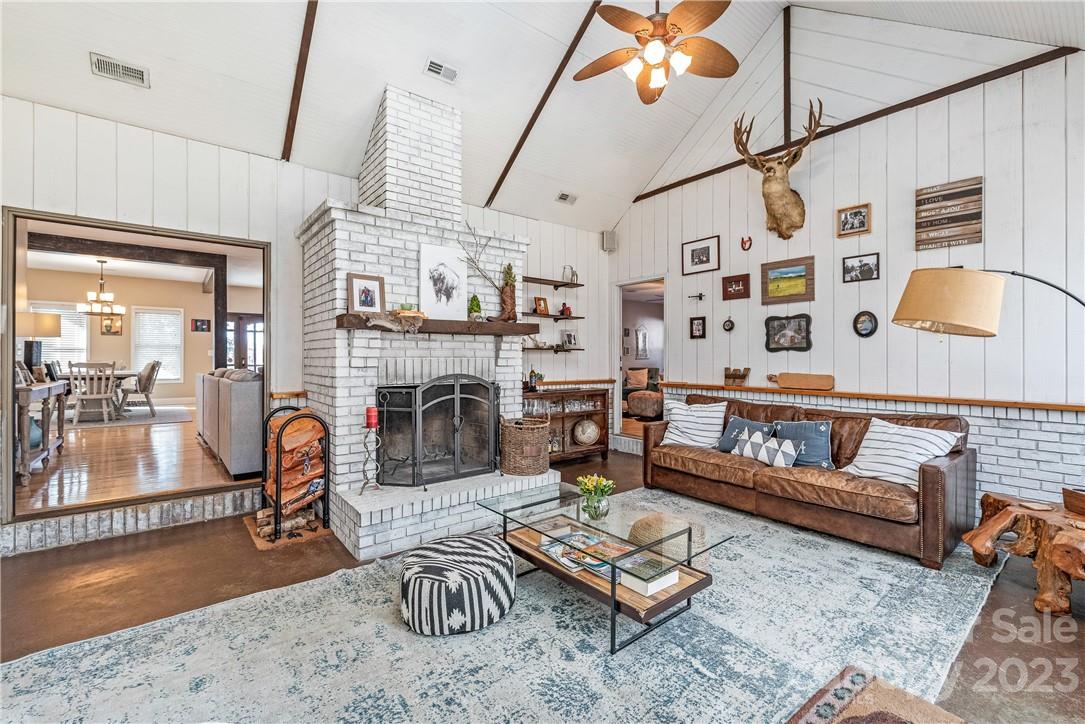 13801 East Rocky River Road Davidson, NC 28036 - Photo 19 of 42 a living room with furniture a fireplace and next to a window