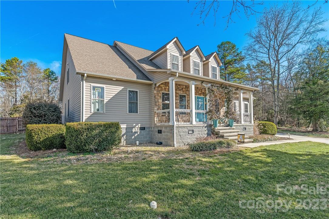 13801 East Rocky River Road Davidson, NC 28036 - Photo 2 of 42 a front view of a house with a yard