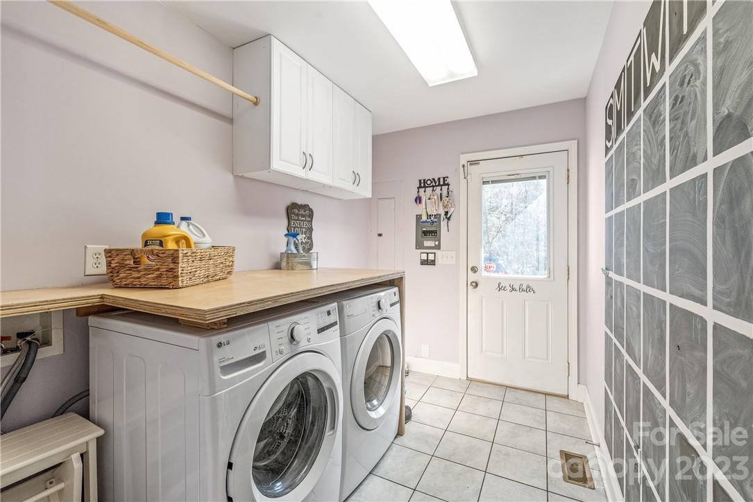 13801 East Rocky River Road Davidson, NC 28036 - Photo 24 of 42 a utility room with cabinets washer and dryer