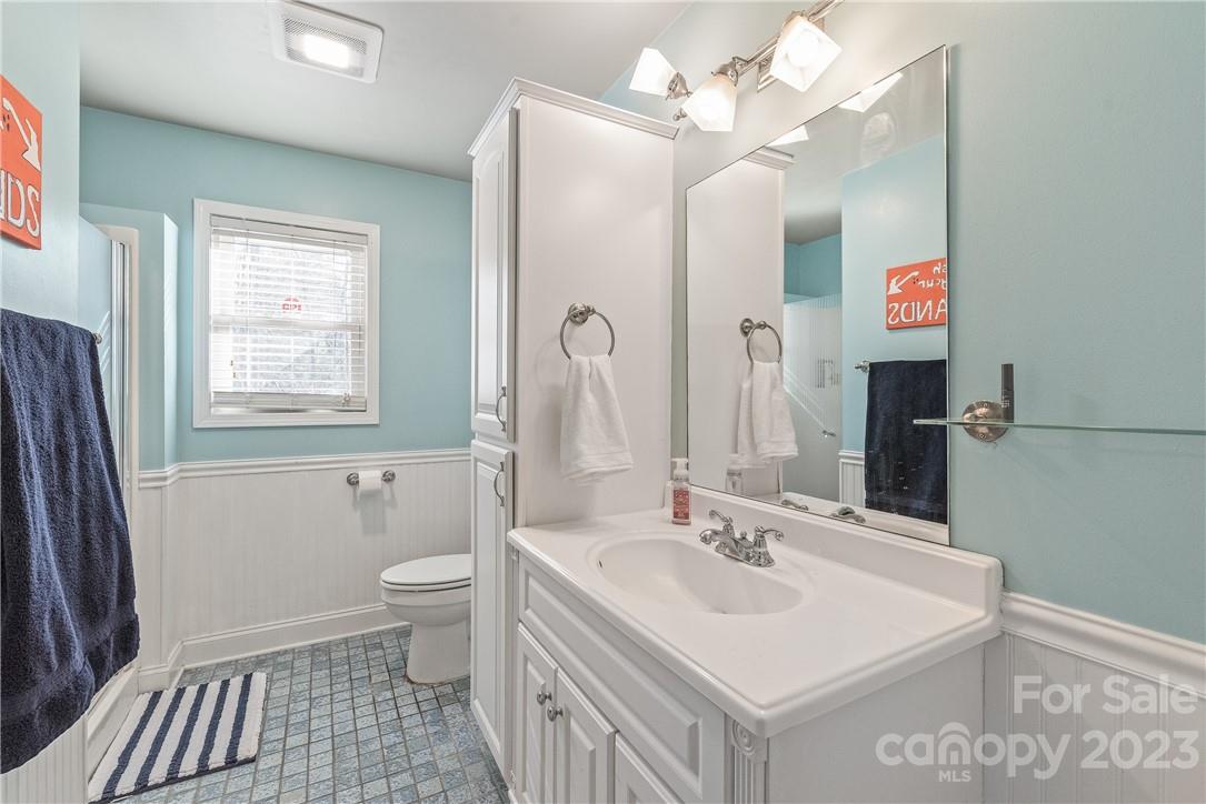 13801 East Rocky River Road Davidson, NC 28036 - Photo 26 of 42 a bathroom with a sink a toilet and a mirror