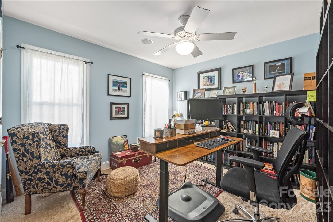 13801 East Rocky River Road Davidson, NC 28036 - Photo 27 of 42 a living room with furniture a flat screen tv and a window