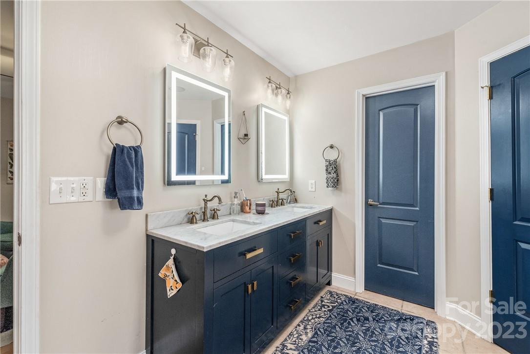 13801 East Rocky River Road Davidson, NC 28036 - Photo 30 of 42 a bathroom with a double vanity sink and mirror