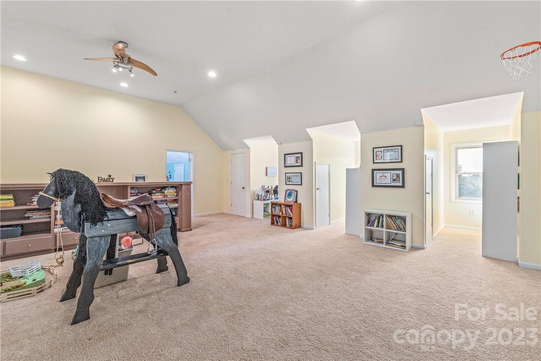 13801 East Rocky River Road Davidson, NC 28036 - Photo 32 of 42 a view of a livingroom with furniture and a ceiling fan