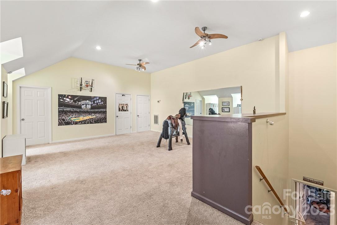 13801 East Rocky River Road Davidson, NC 28036 - Photo 33 of 42 a view of a livingroom with furniture and a ceiling fan