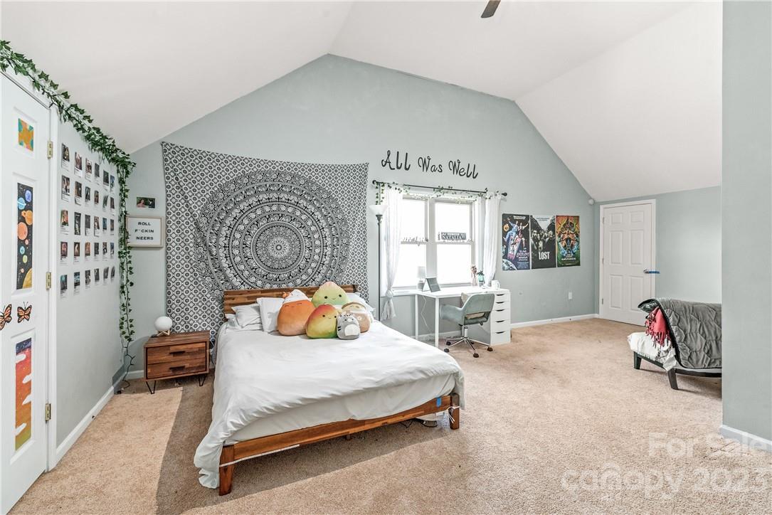 13801 East Rocky River Road Davidson, NC 28036 - Photo 34 of 42 a bedroom with a bed and a window